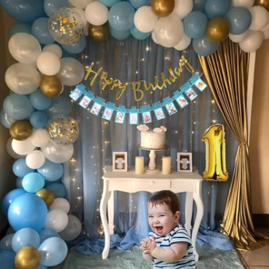 SpecialYou.in 1st Birthday Decoration Combo for Boys – Net Fabric Backdrop, Gold Number “1” Foil Balloon, 40ft Fairy Light, Confetti Balloons & Monthly Milestone Banner