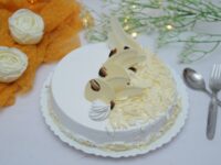 White Forest – Soft vanilla sponge layered with cream, cherries, and white chocolate flakes.